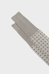 Close-up of the geometric micro-pattern and cuff on Bresciani Nicola socks, in a pearl color.