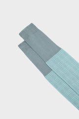 Close-up of the Prince of Wales jacquard pattern and cuff on Bresciani Silvio socks, in teal and aquamarine.