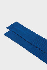 Close-up of the ribbed knit and cuff on Bresciani Cesare socks, highlighting the high cuff and the solid ocean color.