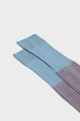 Close-up of the fine ribbed texture on the cuff of Bresciani Mario socks, in a teal red color.
