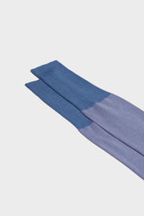 Close-up of the herringbone pattern and the high cuff on Bresciani Giulio socks, in a light blue pink color.