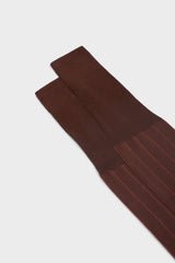 Close-up of the ribbed knit and cuff on Bresciani Leone socks, in a solid rust color.