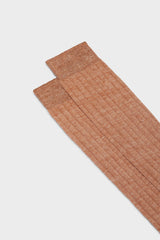 Close-up of the ribbed knit and hand-linked toe on Bresciani Valerio socks, in a solid orange color.