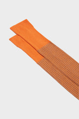 Close-up of the fine ribbed texture on the cuff of Bresciani Mario socks, in a orange blue color.