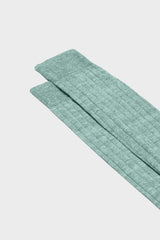 Close-up of the ribbed knit and hand-linked toe on Bresciani Valerio socks, in a solid green color.