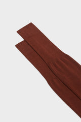 Close-up of the ribbed cuff on Bresciani Lorenzo socks, in a solid burnt color.