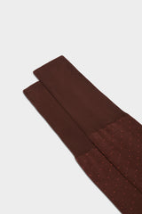 Close-up of the pindots pattern on the cuff of Bresciani Fabio socks, in a brown orange color.
